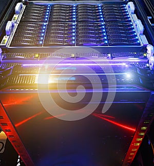 Computer Server mount on rack in data center room with red lighting alarm. bottom view on the cluster storage of