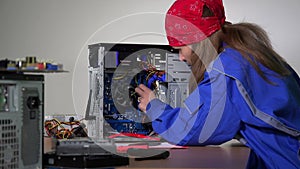Computer service specialist woman remove and examine ram memory plate