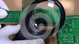 Computer specialist examine RAM memory module with magnifying glass