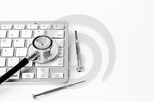 Computer with stethoscope. Tech support or repaire pc system concept photo