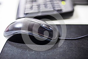 computer stylish wired mouse on a dark background. Orgonomics