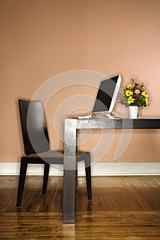 Computer on Table with Flowers