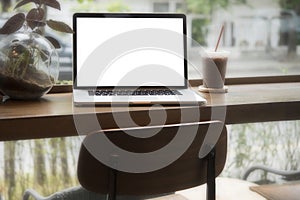 Computer on the table inside coffee shop