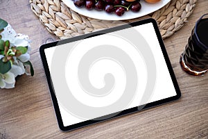 Computer tablet with isolated screen on table in cafe