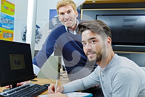 computer teacher assisting student