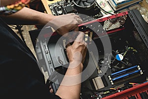 A computer technician assembles a desktop computer with new parts. Upgrading or replacing PC parts