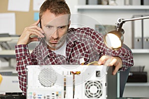 Computer technician consulting users on phone