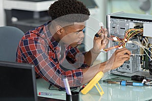 computer technician examining cables in pc