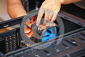 Computer technician installs cooling system of computer.