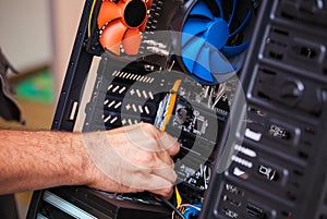 Computer technician installs cooling system of computer. photo
