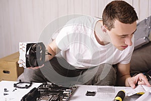 Computer technician installs cooling system of computer. Engineer repairing computer pc board. Technician plug in electronic