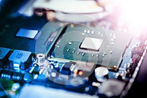 Computer Technology: Close up of a computer chip on a circuit board. Light effect