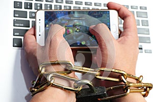 A computer is tied to a man`s hand by a sturdy chain.