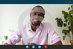 Computer webcam view African applicant pass job interview by videoconference photo