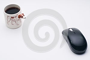 Computer wireless mouse, cup of coffee, Jack Russel dog side of coffee cup