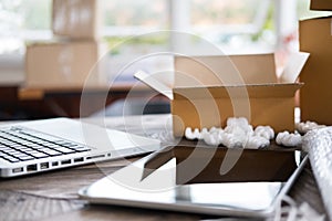 computer at workplace of start up, small business owner, freelance, entrepreneur, SME seller. cardboard parcel box of product for