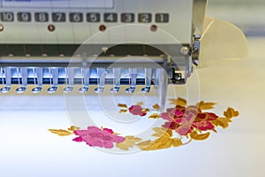 Computerized embroidery machines. sewing machine on blurred background. textile workshop. closeup