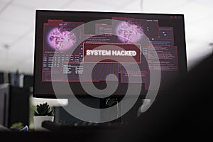 Computers displaying hacked system alert message showing on screen