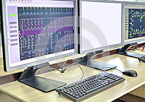 Computers and monitors with schematic diagram for supervisory, control and data acquisition