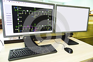 Computers and monitors with schematic diagram for supervisory, control and data acquisition