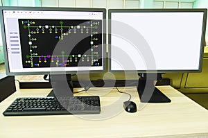 Computers and monitors with schematic diagram for supervisory, control and data acquisition