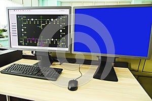 Computers and monitors with schematic diagram for supervisory, control and data acquisition