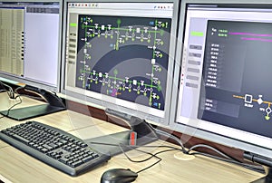 Computers and monitors with schematic diagram for supervisory, control and data acquisition