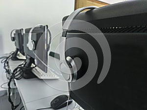 Computers placed in line on a table in a computer classroom