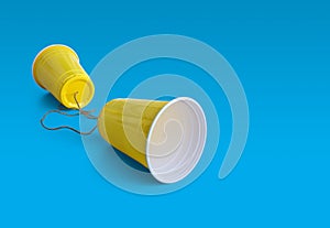 Comunication Yellow Plastic cup with string photo