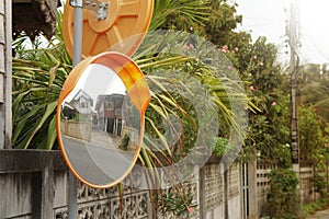 The concave mirror is attached to the corner of the street or opposite the house entrance. photo