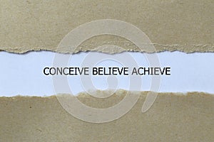 conceive believe achieve on white paper photo