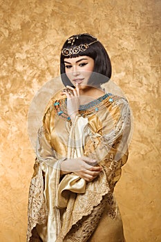 Conceived Beautiful woman like Egyptian Queen Cleopatra on golden background