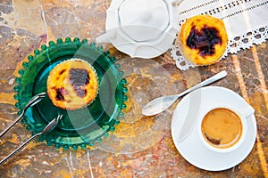 Conceived with the morning coffee and cakes Pasteis de nata, typical pastry from Portugal on natural marble surface.