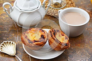 Conceived with the morning coffee and cakes Pasteis de nata, typical pastry from Portugal on natural marble surface.