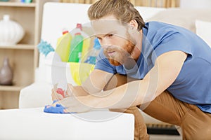 concentrate man cleaning sofa