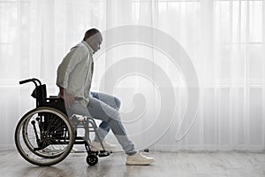 Concentrate tense mature african american man disabled stands up from wheelchair