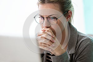 Concentrate young business woman looking her computer while thinking in the office