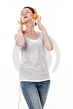 Concentrated 30s female musician listening to music