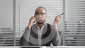 Concentrated african american male ceo negotiating on smartphone with client.