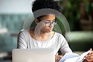 Concentrated african beautiful woman studying reading a book