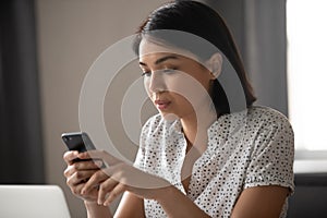 Concentrated asian japanese business woman texting message in cellphone. photo