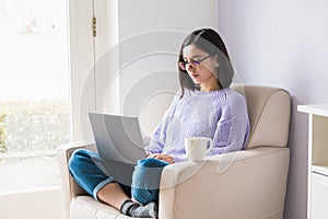 Concentrated beautiful young woman professional in casual clothes working from home on computer because of lockdown