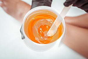 Concentrated beauty salon worker choosing sugar mixture