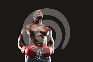 Concentrated black boxer preparing himself for fight