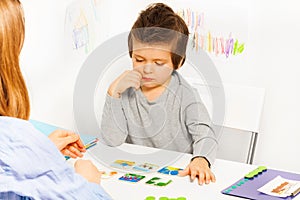 Concentrated boy plays developing game at table