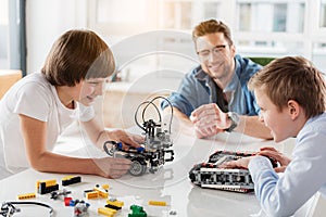 Concentrated boys using technical toys for play photo