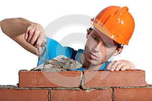 Concentrated bricklayer putting photo