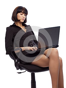 Concentrated brunette woman in dark dress sitting photo