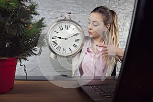 concentrated business woman shows on watch, reminds about holidays