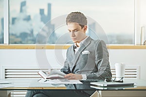 Concentrated businessman reading book